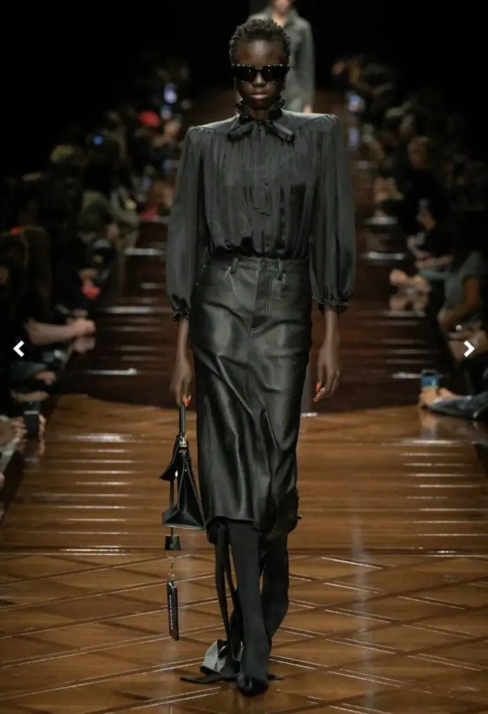 Model in black pleated blouse and skirt from Balenciaga Spring 2025