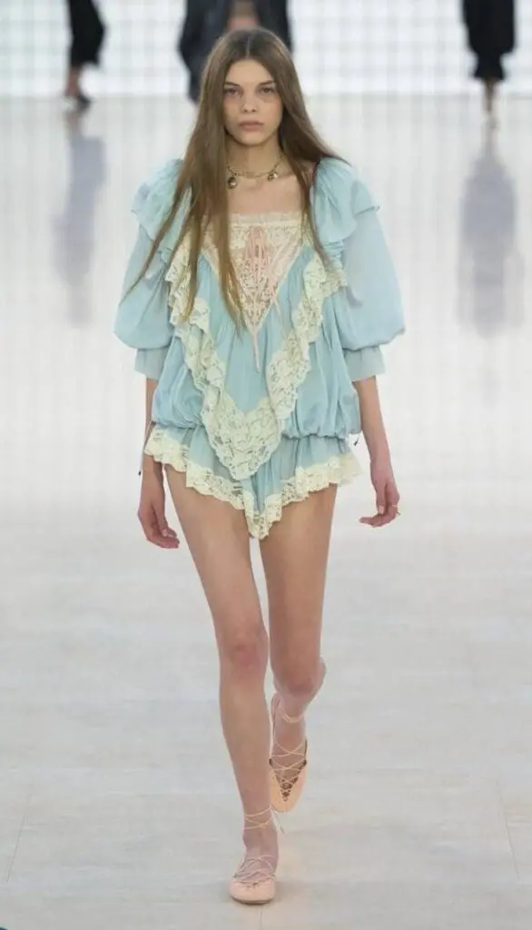 Model in light blue lace-trimmed boho romper from Chloé 2025 runway