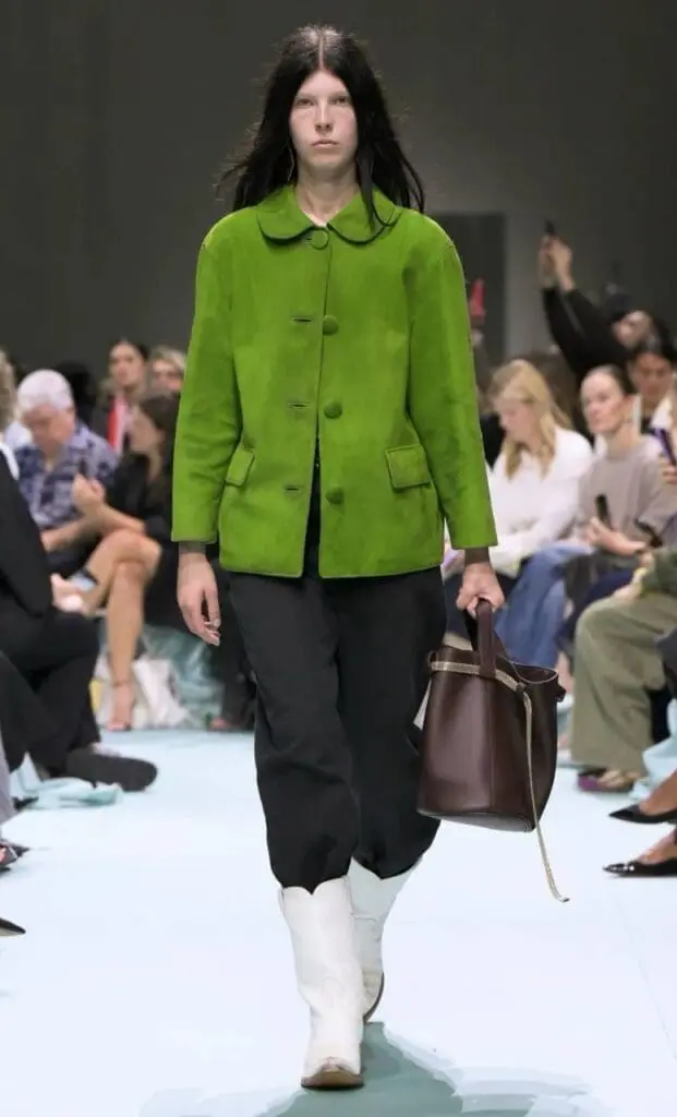 Model in green Prada suede jacket with white western boots