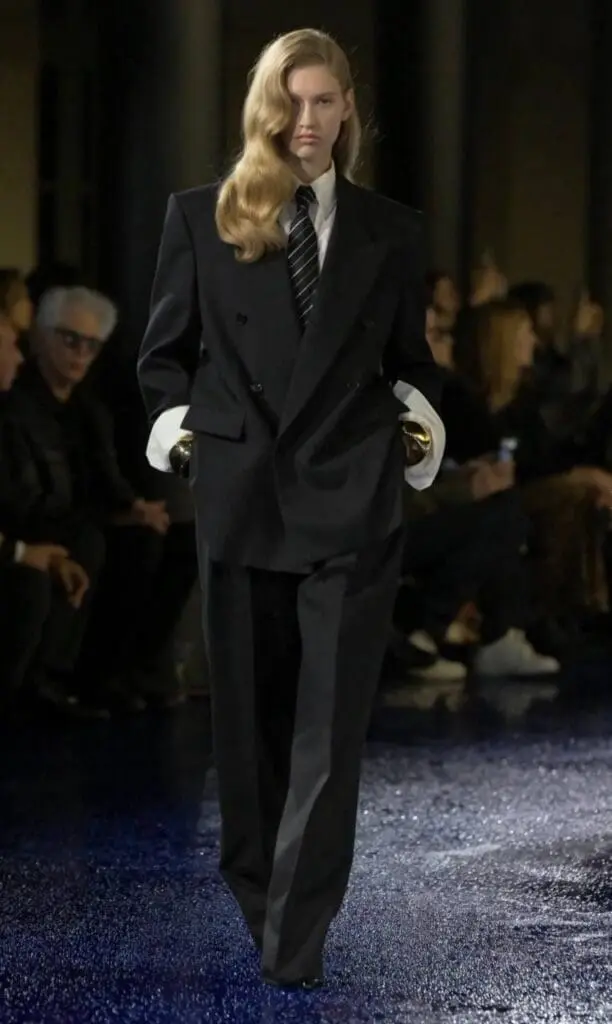 Model in sharp black double-breasted suit with oversized white cuffs
