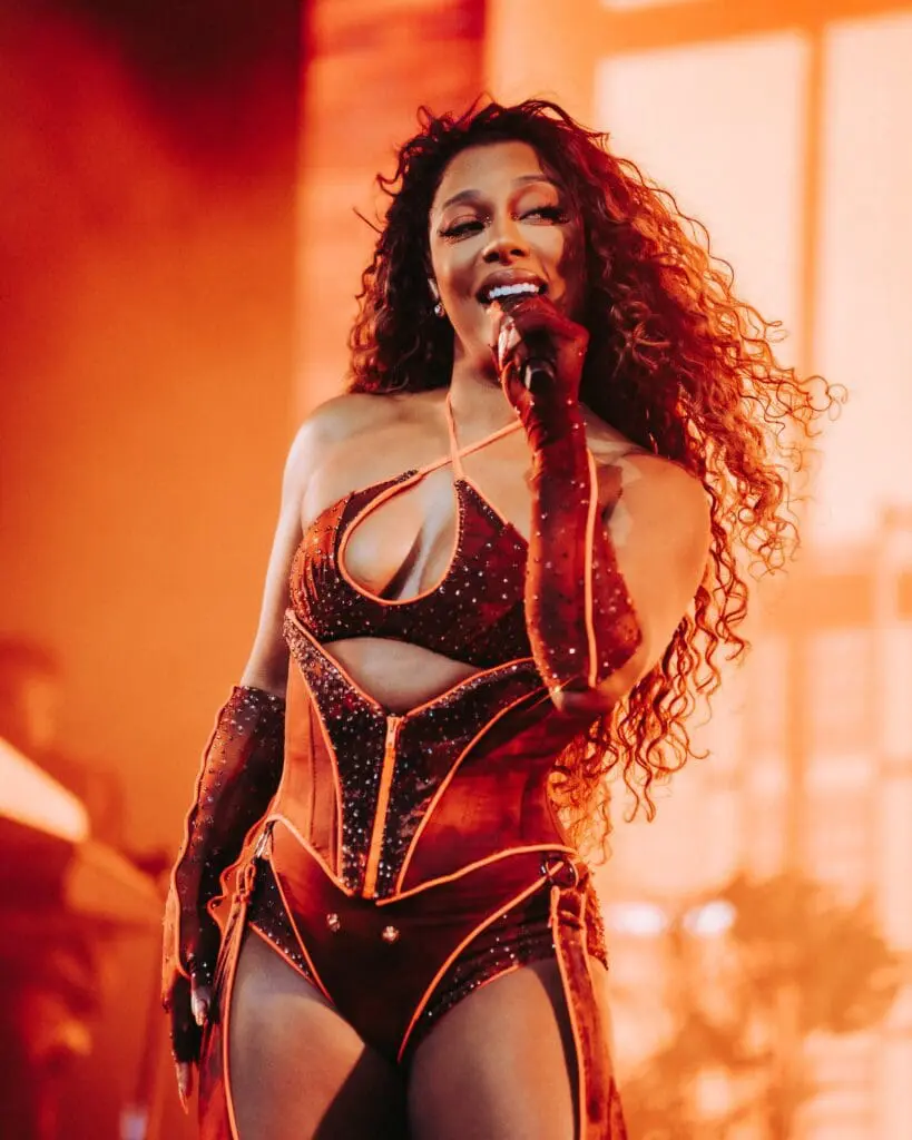 Victoria Monét singing in a red sparkly bodysuit