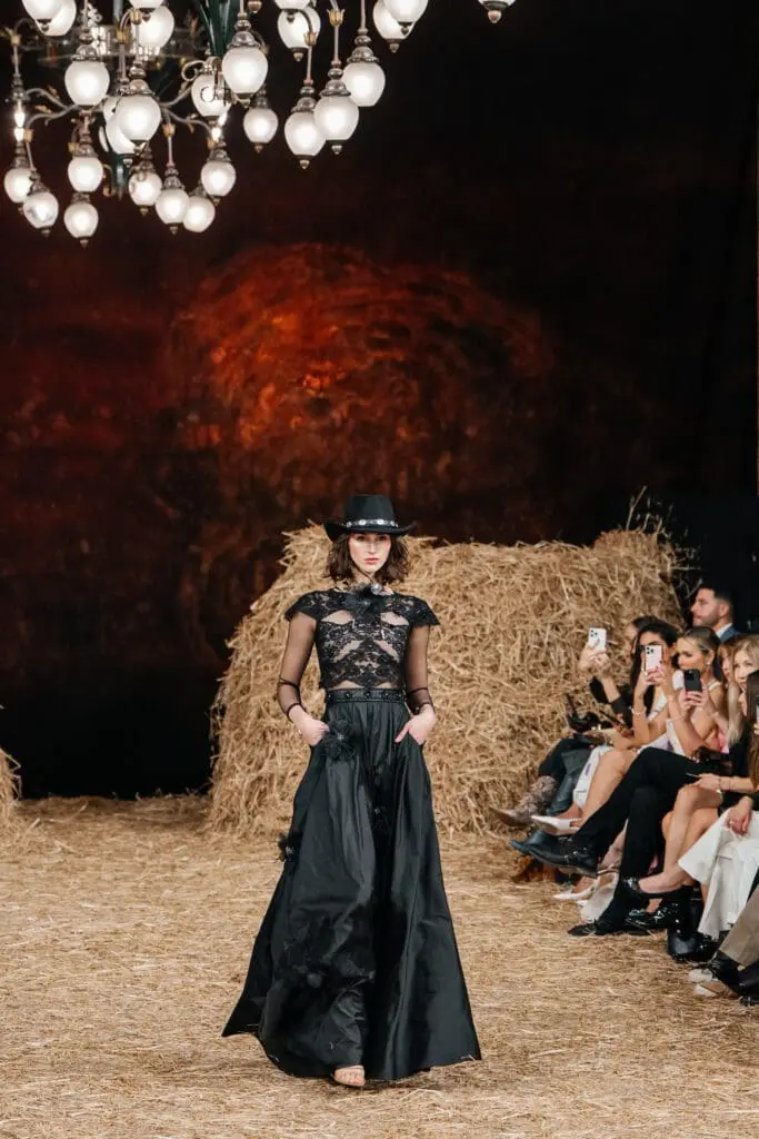 Black lace maxi dress with cowboy hat on runway