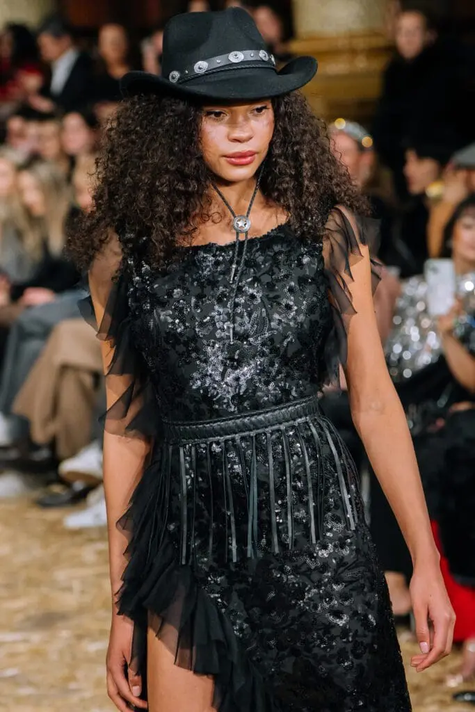 Black sequin dress with fringe belt, bolo tie