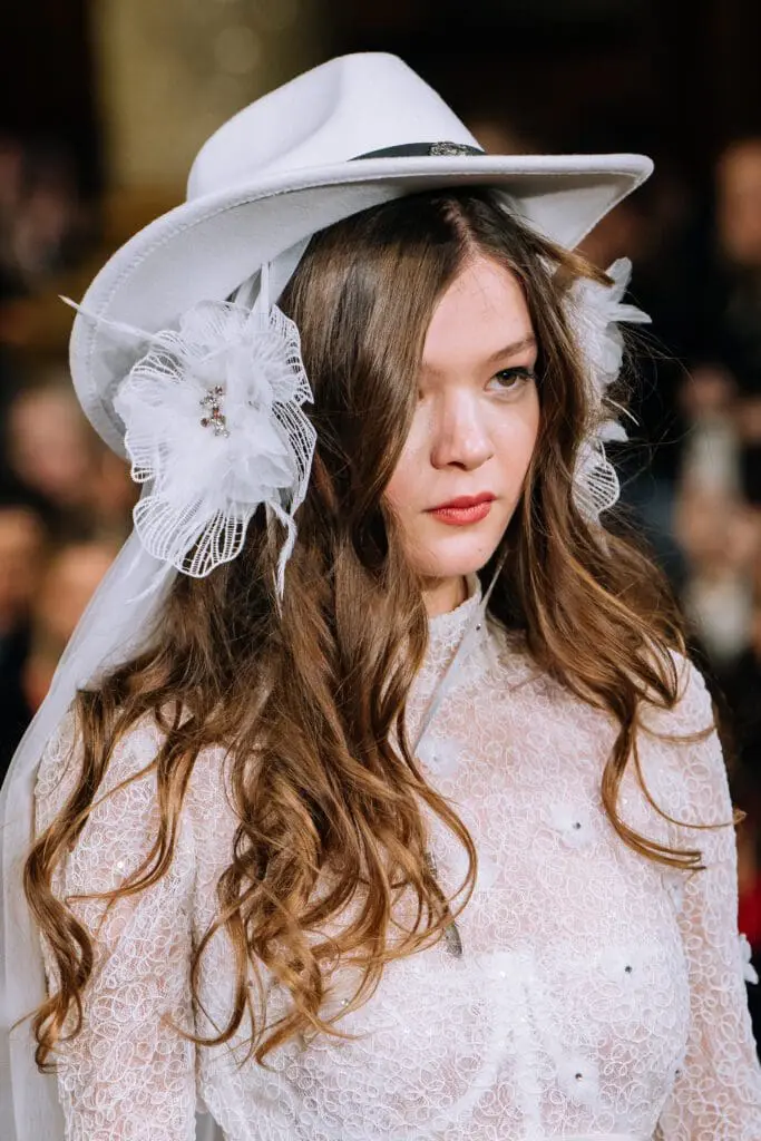 Close-up bridal look with white hat and veil