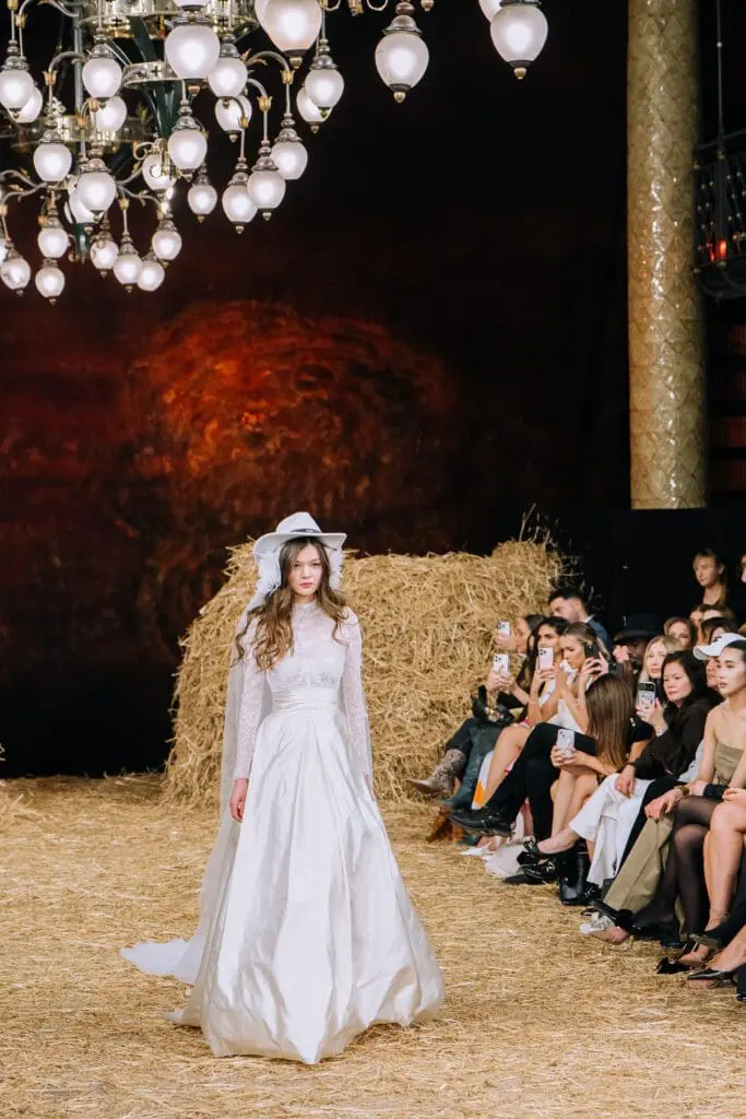 Runway bridal gown with white hat and veil