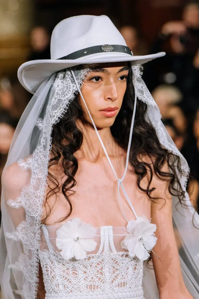 Bridal look with lace-edged veil and flowers