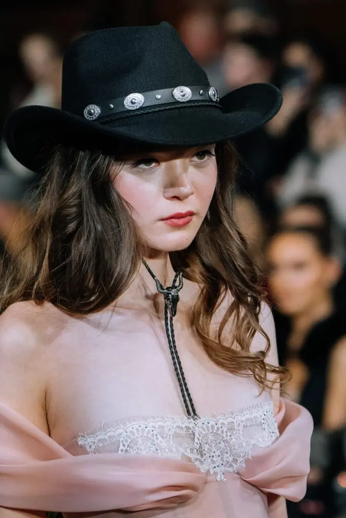 Sheer pink lace bodice with black cowboy hat