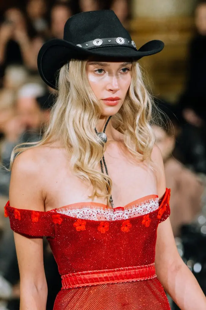Black hat, red off-shoulder sequin dress close-up