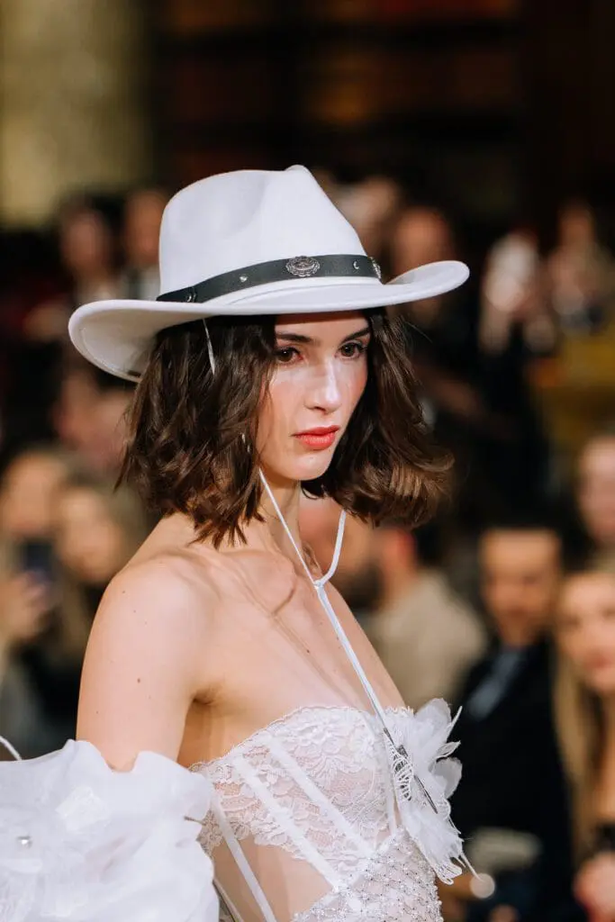 Close-up white cowboy hat and lace bodice