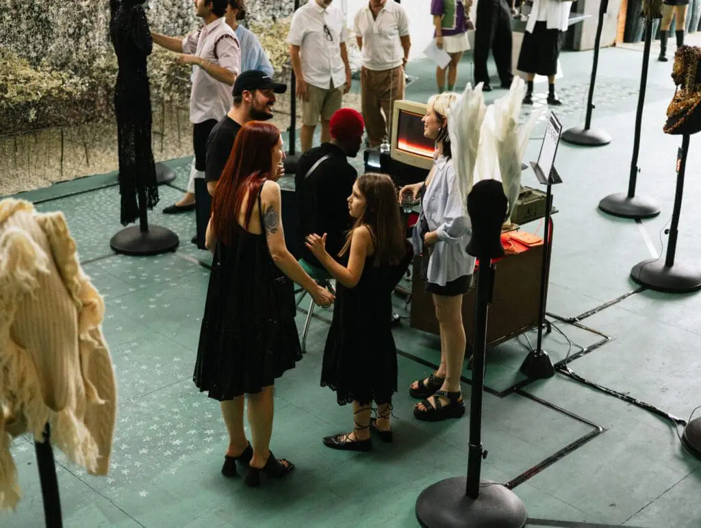 Visitors interacting with Agglomerati Milan exhibition pieces
