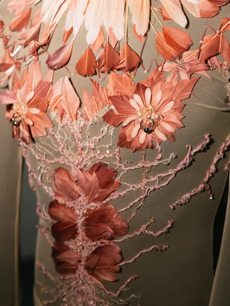 Close-up of feather floral detailing on fashion costume