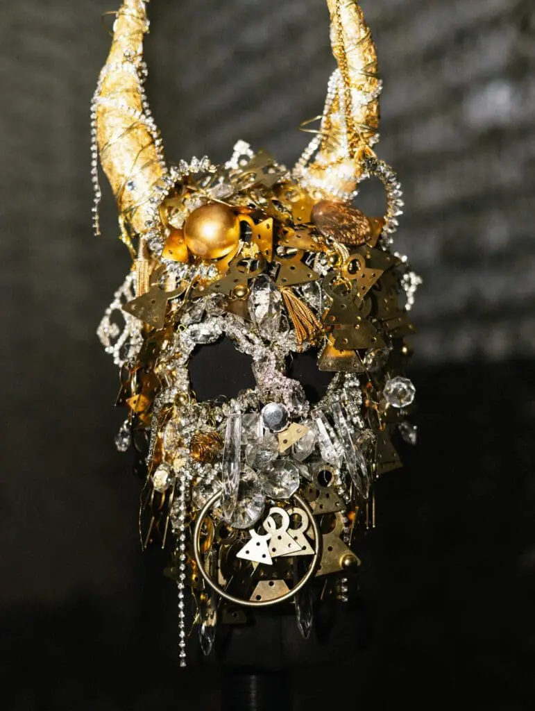 Golden horn mask decorated with crystals and ornaments