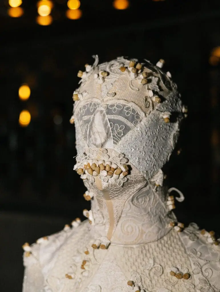 White lace mask costume with beads and stitched details