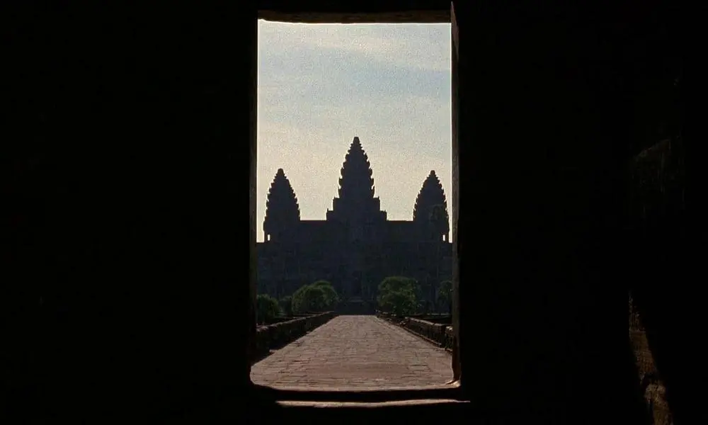 View of Angkor Wat temple framed by stone doorway