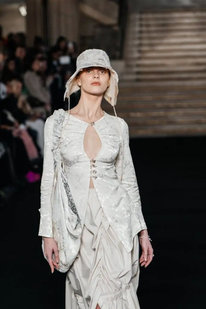 Model in layered black and white structured outfit