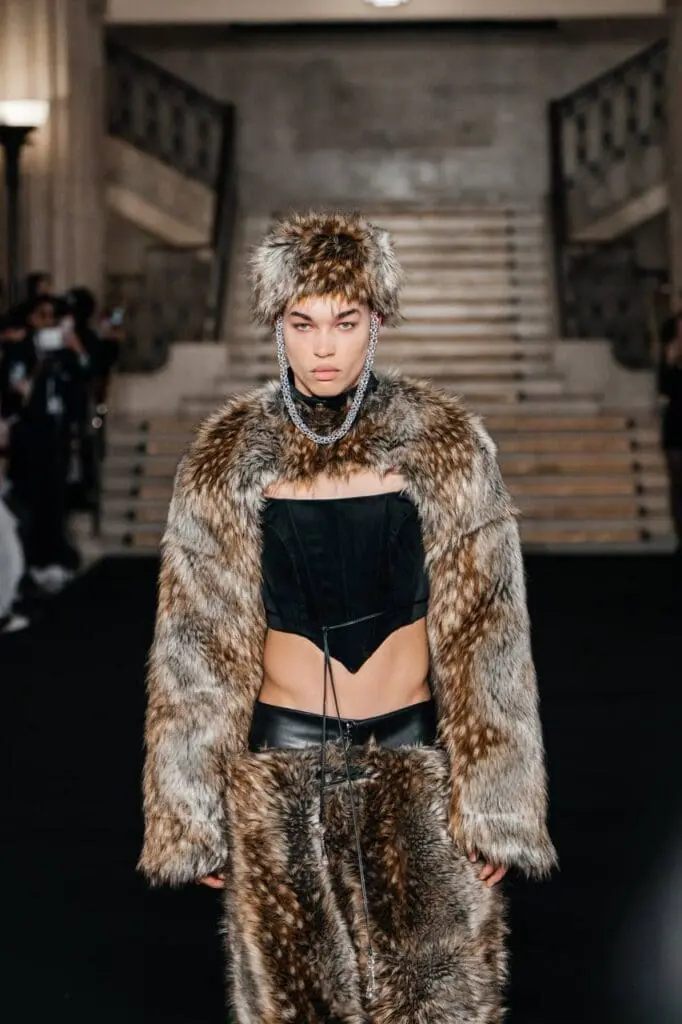 Model in faux fur coat with black corset and leather