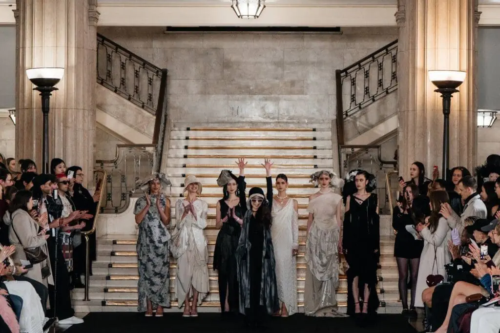 Angus Tsui runway finale with models in neutral gowns