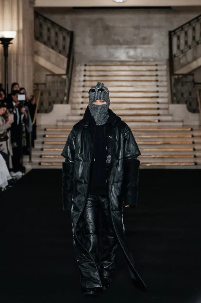 Model in black leather coat and knit balaclava