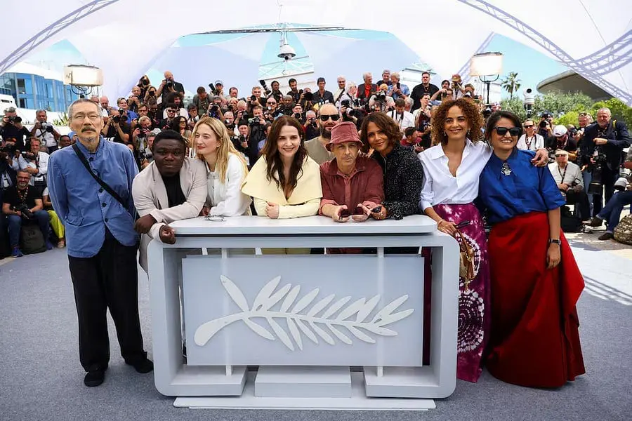 The full jury of Cannes 2025 posing in front of photographers at the festival venue