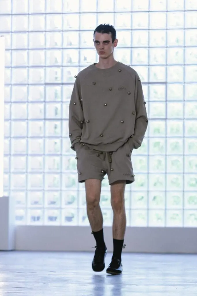 Beige sweater with metallic herding bells detail SS26