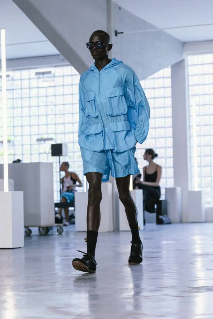 Model in blue utility jacket SS26 Problems