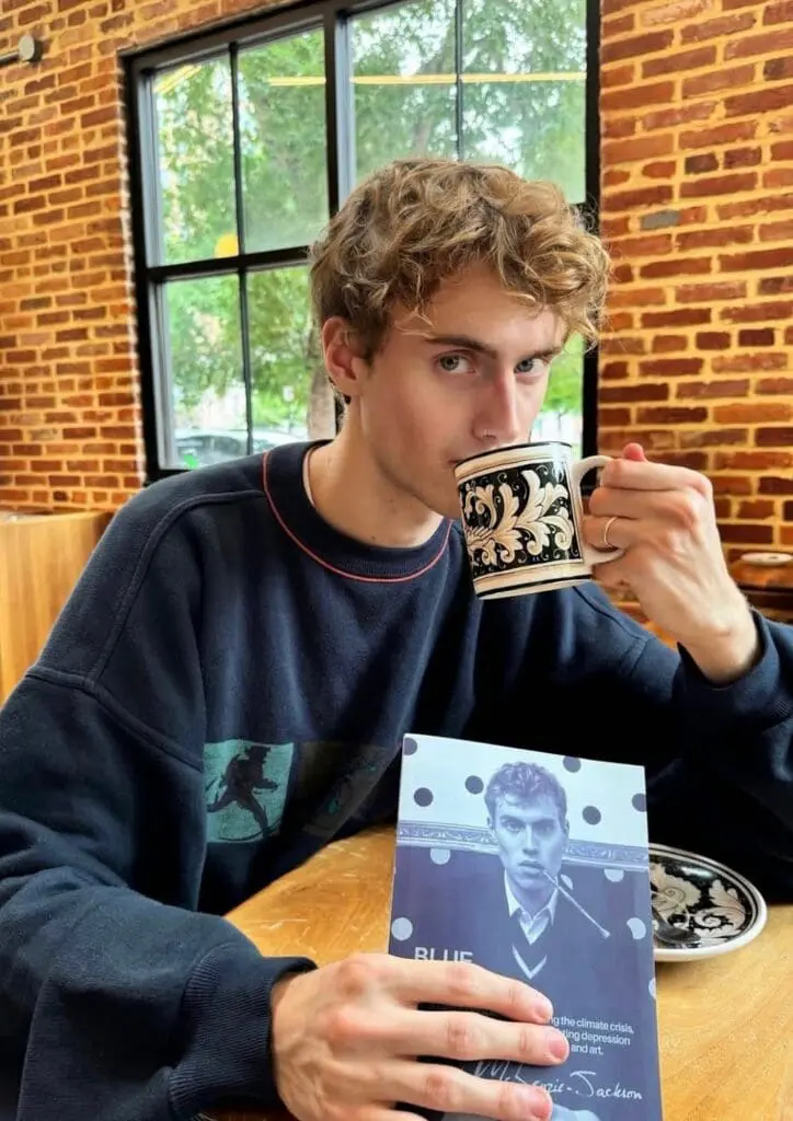 Elijah McKenzie-Jackson with coffee and BLUE book