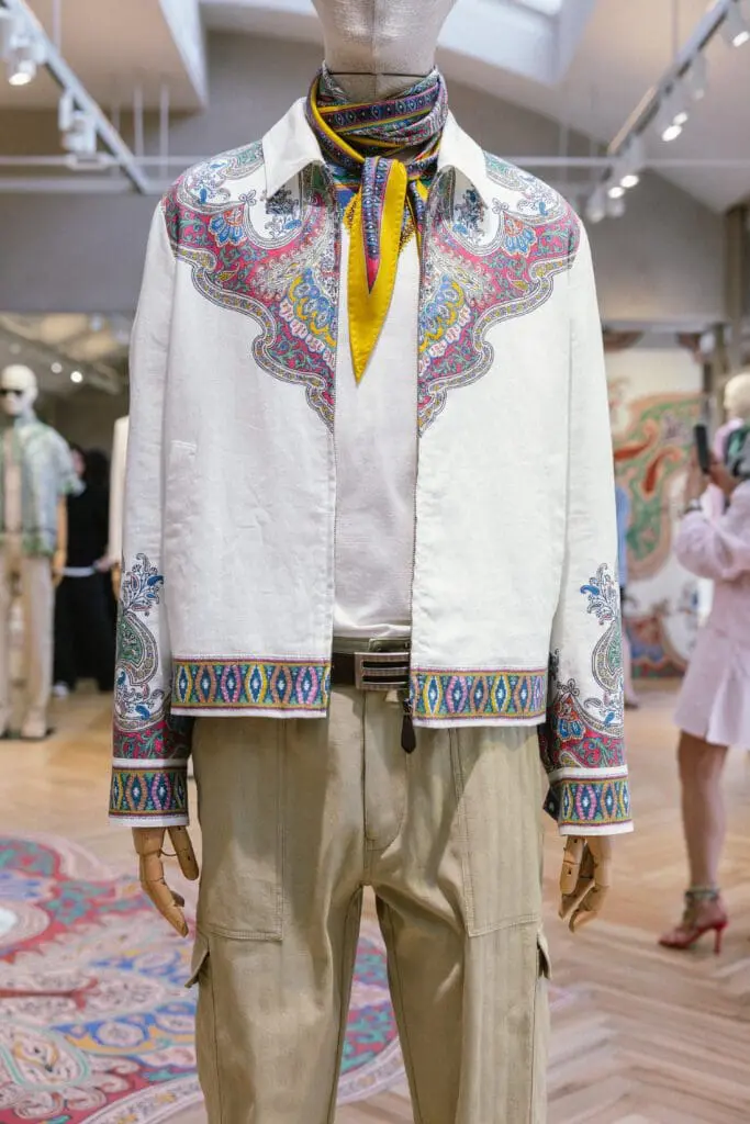 Etro Spring Summer 2026 menswear green paisley silk shirt layered over a cream tee, styled with a matching silk neck scarf.