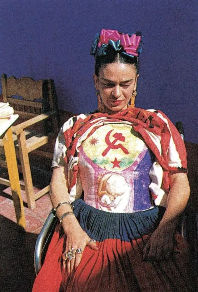 Frida Kahlo wearing a corset with Marxist symbols and fetal imagery