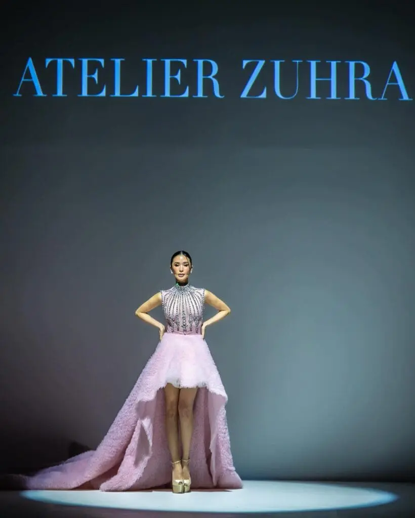 Heart Evangelista wearing a pastel pink Atelier Zuhra gown on the runway