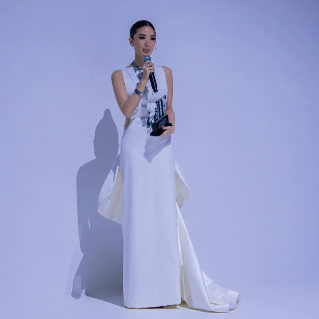 Heart Evangelista in white Michael Leyva gown holding Fashion Icon award at The Fashion Factor Dubai