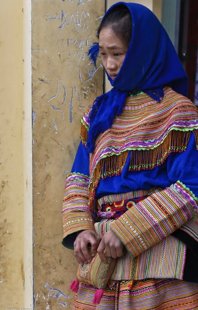 Young Hmong girl wearing traditional handwoven clothing and blue headscarf