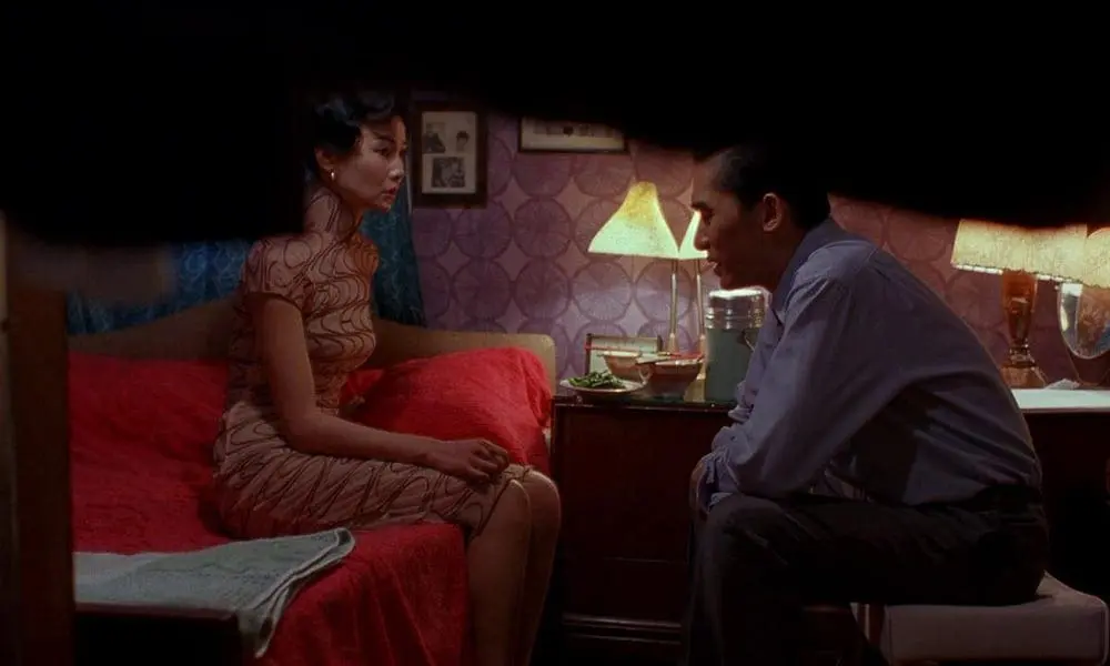 Su Li-zhen and Chow Mo-wan talk inside a dimly lit bedroom