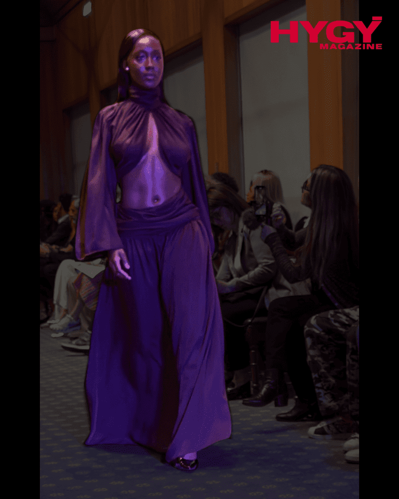 Model in sheer brown chiffon top and skirt at fashion show