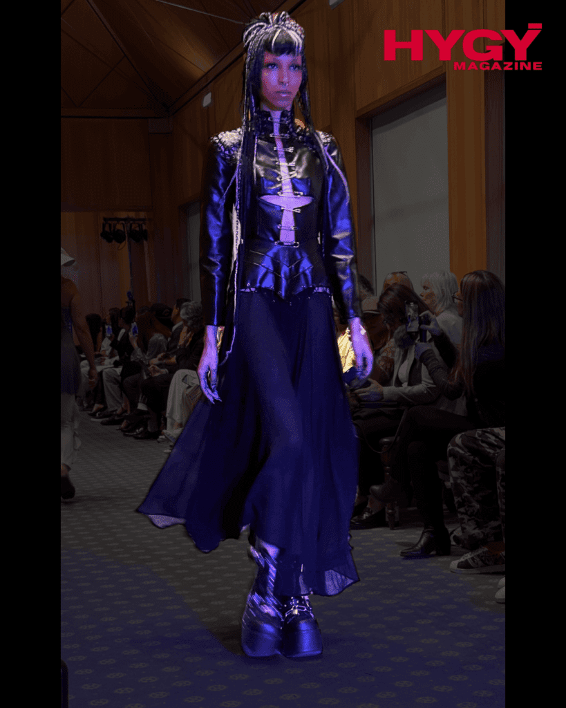 Model in black leather corset and spike headpiece walking runway at Jimmy Choo Academy