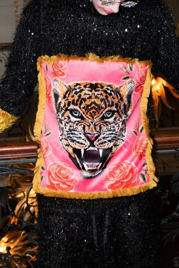 Close-up of tiger applique on pink fabric with rose print