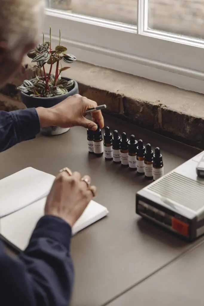 Maya Njie arranging aroma oils at her desk