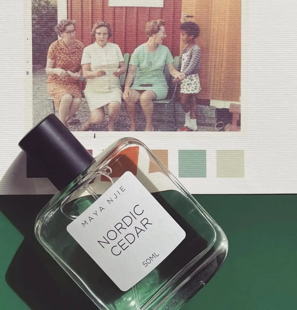 Perfume bottle of Nordic Cedar placed over a vintage family photo