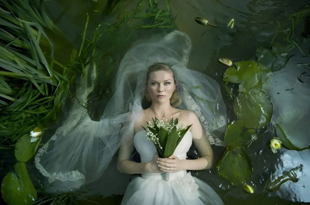 Scene from Lars von Trier’s Melancholia. Bride in white dress floating in water with lilies
