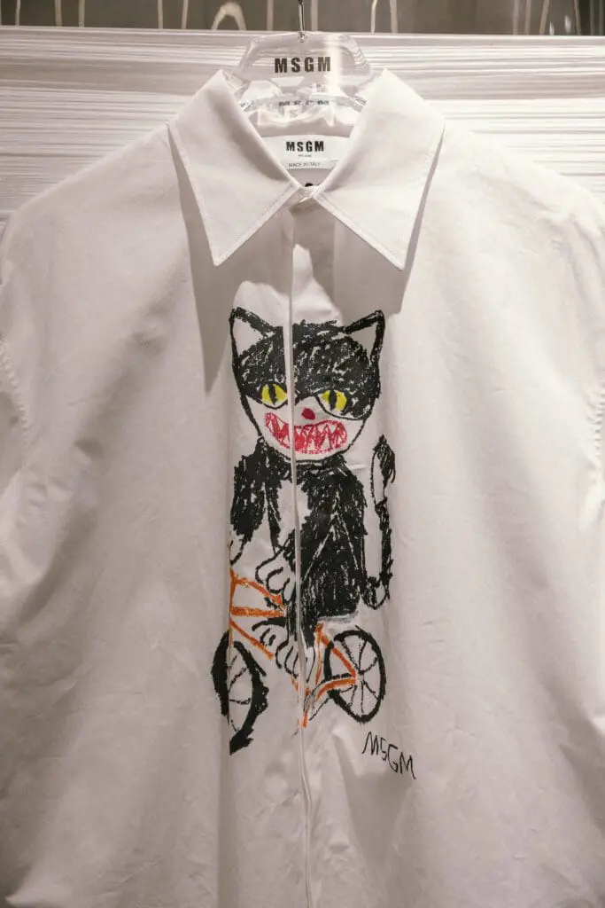 White shirt with playful black cat on bicycle graphic from MSGM SS26