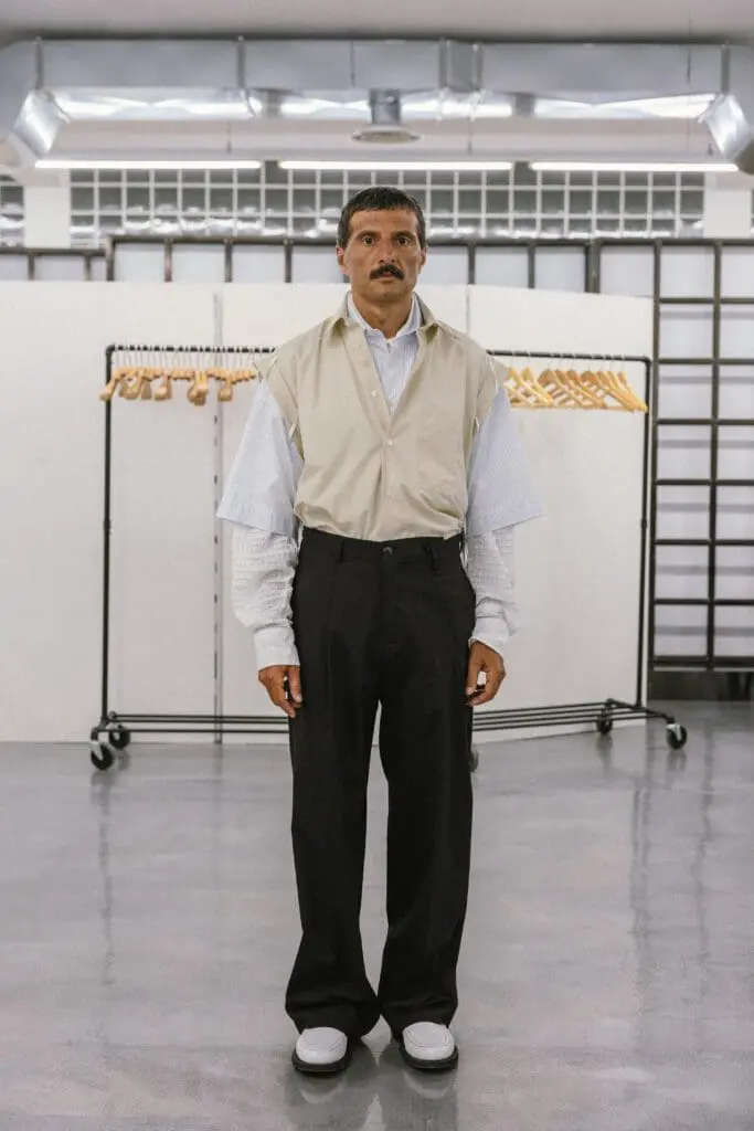 Male model in beige short-sleeve shirt over stripes