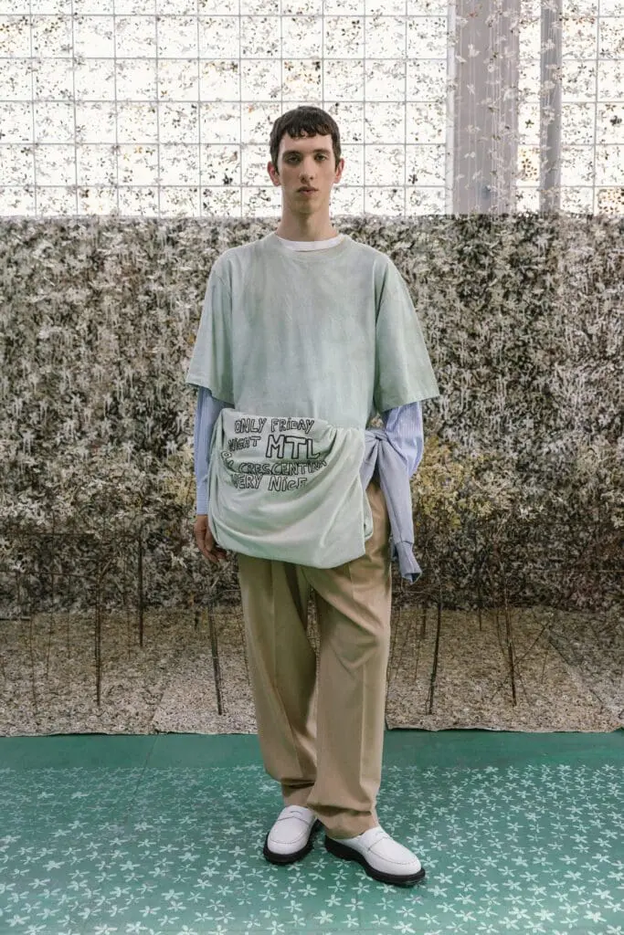 Male model in mint green shirt and beige trousers