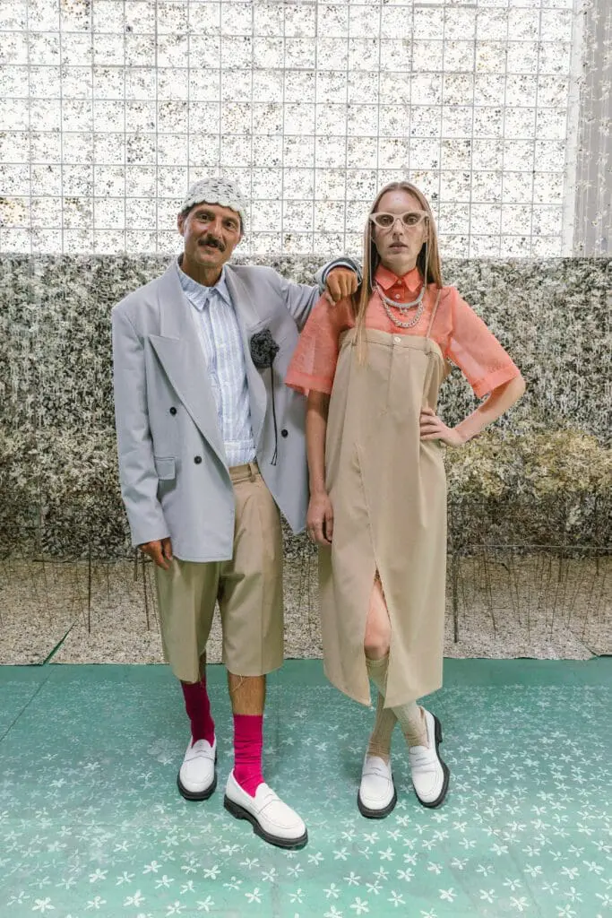Two models in beige and pastel looks with white loafers