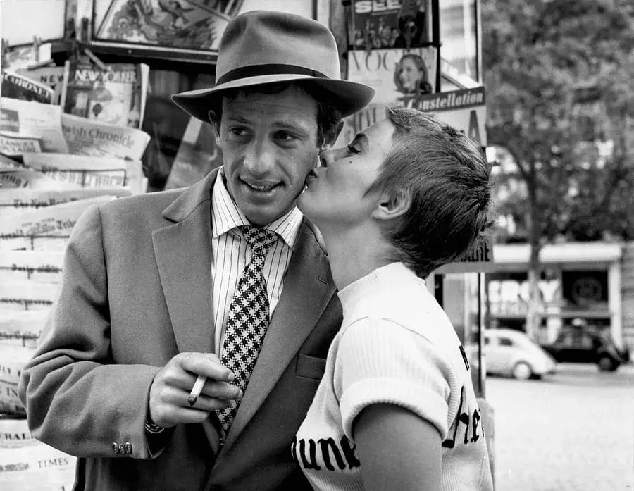 Iconic black-and-white image of Belmondo being kissed by Seberg on Paris street