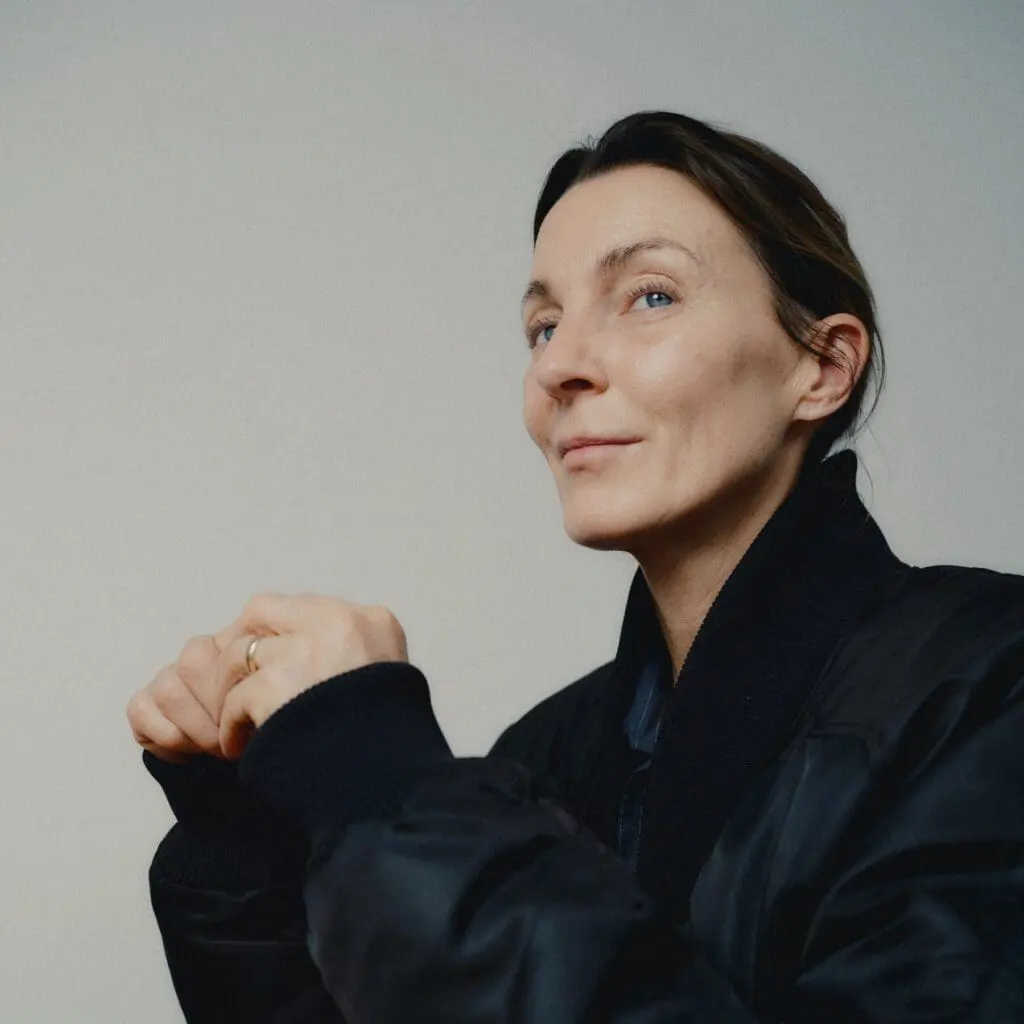Phoebe Philo in a black coat looking into the distance