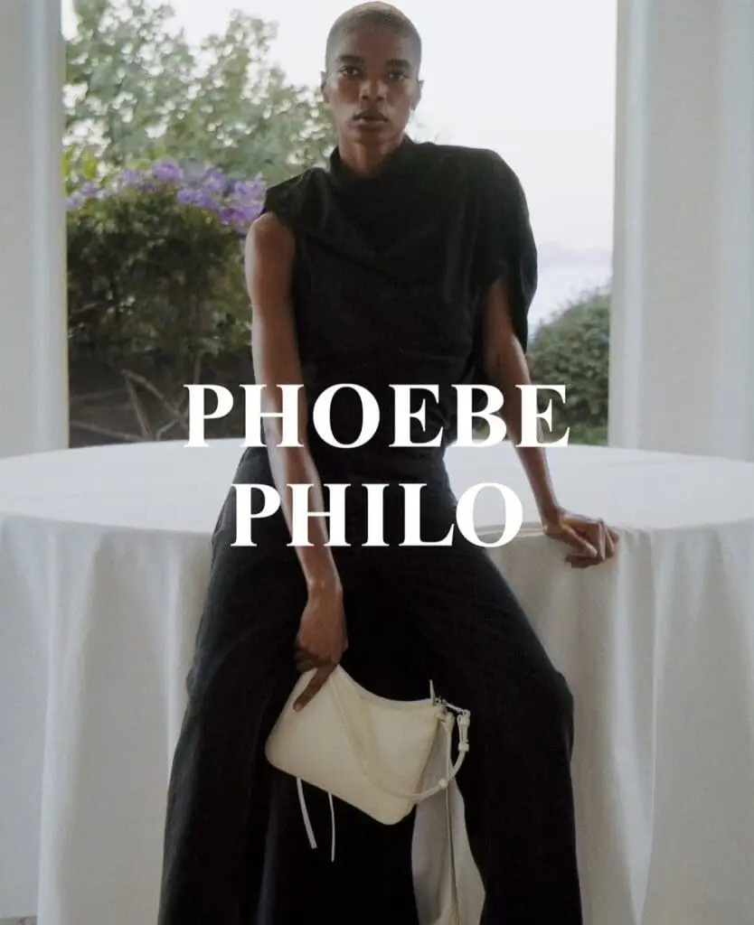 Model in Phoebe Philo campaign with white handbag and black outfit