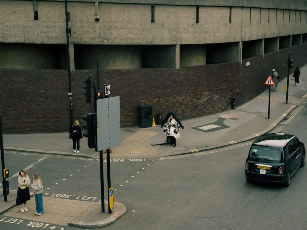 Wide shot of eccentric streetwear juxtaposed with daily life