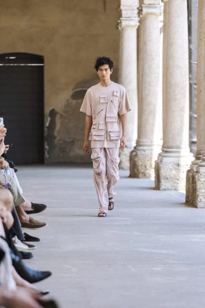 Model in layered white coat QASIMI SS26 MFW