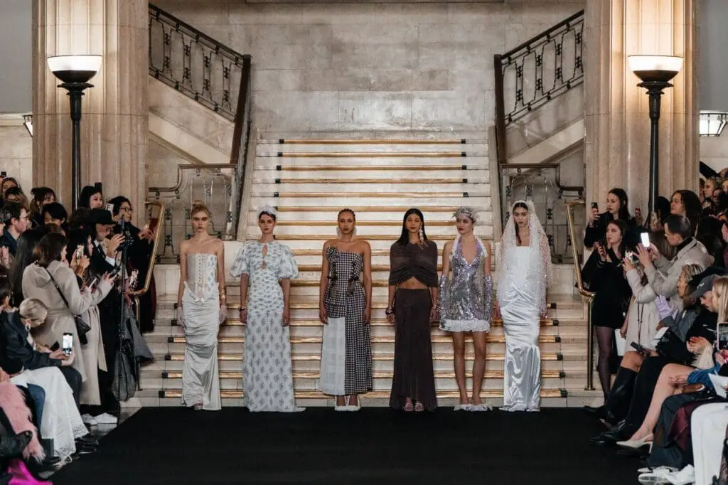 Runway finale with six models in neutral and silver