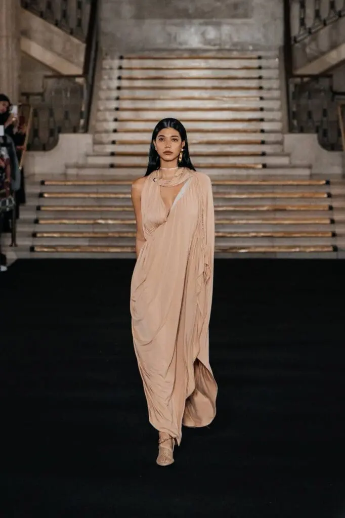 Model in asymmetric orange and pink sculptural dress