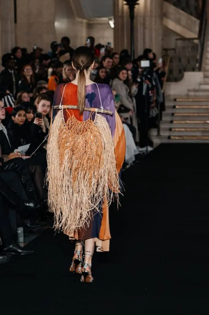 Model in multicolor sculpted dress with voluminous skirt